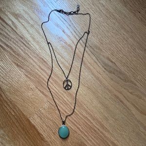 Double layered peace necklace with green gemstone